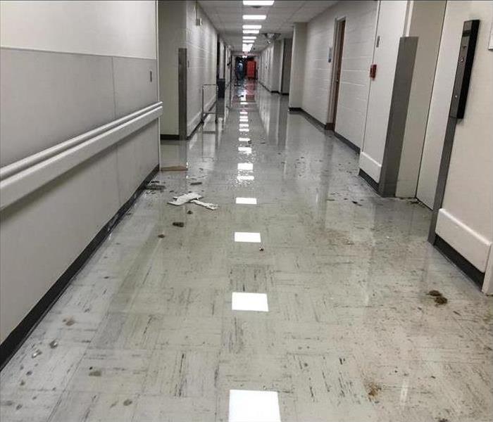 hospital hallway with standing water from sprinkler system malfunction